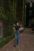 straight leg jeans in a dark wash paired with a black short sleeve body women
