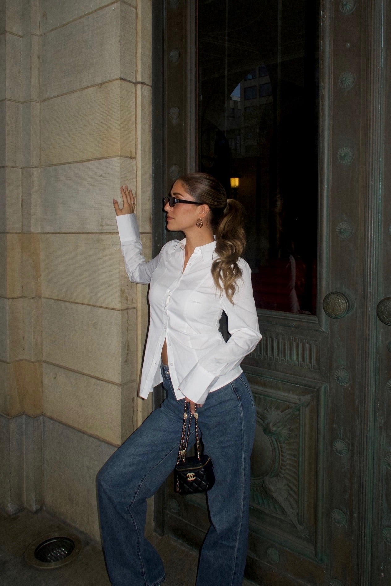straight leg jeans in a dark wash paired with a off-white blouse women